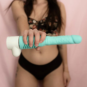 women holding a velvet thruster prime model adult sex toy with jackie top in mint green and base color white